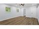 Bedroom with vinyl floors, white walls, a ceiling fan, two windows, and a door to the bathroom at 2223 Columbia Dr, Decatur, GA 30032