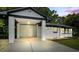Attached carport with access door and adjacent view of the house's front facade at 2223 Columbia Dr, Decatur, GA 30032