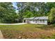Exterior of a single Gathering home with an open front yard and elongated driveway at 2223 Columbia Dr, Decatur, GA 30032