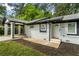 Quaint white brick home featuring a covered carport and fresh landscaping at 2223 Columbia Dr, Decatur, GA 30032