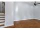 Open living room featuring hardwood floors, neutral walls, a ceiling fan, and stairs to the upper level at 2223 Columbia Dr, Decatur, GA 30032