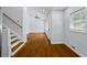 Living room featuring hardwood floors and adjacent staircase leading to the upper floor at 2223 Columbia Dr, Decatur, GA 30032