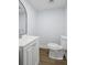 Small powder room with a white vanity, toilet, and modern faucet at 2223 Columbia Dr, Decatur, GA 30032