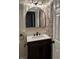 Stylish bathroom with a brick accent wall, modern mirror, and vanity at 3133 Rebecca St, Covington, GA 30014