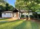 Charming brick home with well-maintained landscaping and a welcoming front porch and wooden door at 3133 Rebecca St, Covington, GA 30014