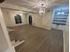 Open living room boasts modern light fixtures, hardwood flooring, and built-in shelving at 3133 Rebecca St, Covington, GA 30014