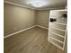 Room view with tan walls, updated lighting, and a bookshelf at 3133 Rebecca St, Covington, GA 30014