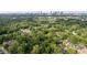 Scenic aerial view of a neighborhood, showcasing lush trees and the city skyline in the distance at 540 Atwood Sw St, Atlanta, GA 30310