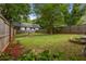 Spacious fenced backyard featuring green grass and a cozy firepit area, perfect for outdoor gatherings at 540 Atwood Sw St, Atlanta, GA 30310