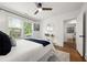 Bright bedroom with white walls, a ceiling fan, and a window view of greenery at 540 Atwood Sw St, Atlanta, GA 30310
