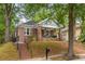 Charming brick home featuring a cozy front porch and professionally landscaped yard at 540 Atwood Sw St, Atlanta, GA 30310