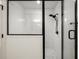 Modern walk-in shower featuring white subway tile, black hardware, and a glass enclosure at 540 Atwood Sw St, Atlanta, GA 30310