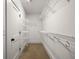 Spacious walk-in closet featuring white shelving and carpeted flooring at 540 Atwood Sw St, Atlanta, GA 30310
