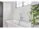 Elegant bathroom featuring a soaking tub, modern fixtures, and stylish decor at 797 Greenwood Ne Ave, Atlanta, GA 30306