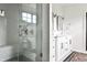 Modern bathroom featuring a glass shower, double sinks, and tile flooring at 797 Greenwood Ne Ave, Atlanta, GA 30306