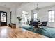 Inviting dining room featuring wood floors, shiplap walls, and a modern chandelier above the round table at 797 Greenwood Ne Ave, Atlanta, GA 30306