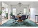 Elegant dining room with shiplap walls, a modern chandelier, and a stylish rug under a round table at 797 Greenwood Ne Ave, Atlanta, GA 30306