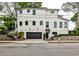 Two-story home with a black garage door, and manicured landscaping at 797 Greenwood Ne Ave, Atlanta, GA 30306