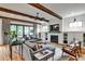 Comfortable living room featuring exposed wood beams, a brick fireplace, and a large sectional at 797 Greenwood Ne Ave, Atlanta, GA 30306