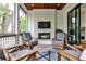 Inviting screened porch with a fireplace, comfortable seating, and wood accents at 797 Greenwood Ne Ave, Atlanta, GA 30306