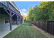 A well maintained and grassy back yard, enclosed with a dark wooden fence and black metal gate, great for a pet at 2128 Sonoma Se Dr, Smyrna, GA 30080