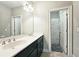 Elegant bathroom features a double sink vanity with modern fixtures and linen closet at 2128 Sonoma Se Dr, Smyrna, GA 30080