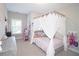 Bright bedroom with canopy bed, playful decor, and neutral walls at 2128 Sonoma Se Dr, Smyrna, GA 30080