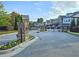 Stone pillars and iron gates mark the community entrance, enhanced with colorful flower beds at 2128 Sonoma Se Dr, Smyrna, GA 30080