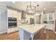 Modern kitchen featuring stainless steel appliances, a center island, and stylish pendant lights at 2128 Sonoma Se Dr, Smyrna, GA 30080