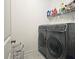 Practical laundry room with modern washer and dryer, and shelving for supplies at 2128 Sonoma Se Dr, Smyrna, GA 30080