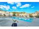 Community swimming pool surrounded by townhomes and lush trees, with clear blue water and concrete decking at 2128 Sonoma Se Dr, Smyrna, GA 30080