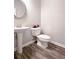 Half bath with pedestal sink, neutral colors, and decorative accents at 3401 Endurance Ct # 10, Atlanta, GA 30349
