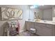 Bathroom featuring a double vanity, decorative art, and ample counter space at 3401 Endurance Ct # 10, Atlanta, GA 30349