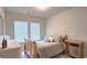 Cozy bedroom with wood-frame bed, side table, and natural light from the windows at 3401 Endurance Ct # 10, Atlanta, GA 30349