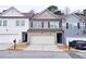Charming townhome with a two-car garage and neutral-colored siding at 3401 Endurance Ct # 10, Atlanta, GA 30349