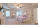 Spacious main bedroom with a tray ceiling, ceiling fan, and large windows at 3401 Endurance Ct # 10, Atlanta, GA 30349