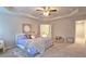 Inviting main bedroom featuring a tray ceiling, ceiling fan, and ensuite bathroom access at 3401 Endurance Ct # 10, Atlanta, GA 30349