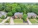 Aerial view of a brick home showcasing its landscaped yard, mature trees, and proximity to neighboring houses at 3722 Somerset Nw Rdg, Kennesaw, GA 30144