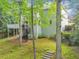 Exterior shot of the house with a large deck, spiral staircase, and lush landscaping at 3722 Somerset Nw Rdg, Kennesaw, GA 30144