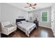 Comfortable bedroom with hardwood floors, natural light, and a chair perfect for relaxation at 3722 Somerset Nw Rdg, Kennesaw, GA 30144