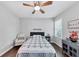 Serene bedroom featuring hardwood floors, ceiling fan, and a cozy reading chair by the window at 3722 Somerset Nw Rdg, Kennesaw, GA 30144