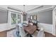 Dining room with a wooden table, rug, chandelier, and a large window with natural light at 3722 Somerset Nw Rdg, Kennesaw, GA 30144