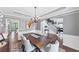Spacious dining room featuring a wooden table, chandelier, wainscoting, and view into the living room at 3722 Somerset Nw Rdg, Kennesaw, GA 30144