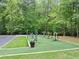 Community outdoor exercise area with modern equipment surrounded by lush greenery and a parking area at 3722 Somerset Nw Rdg, Kennesaw, GA 30144