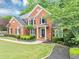 Inviting brick home with a manicured front lawn and lush landscaping at 3722 Somerset Nw Rdg, Kennesaw, GA 30144