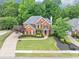 Beautiful brick home with a well-manicured lawn, mature landscaping, and a curved walkway leading to the front door at 3722 Somerset Nw Rdg, Kennesaw, GA 30144