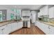 Bright kitchen featuring stainless steel appliances, white cabinets, and granite countertops at 3722 Somerset Nw Rdg, Kennesaw, GA 30144