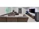 Comfortable living room with a sectional sofa, shelving, and a large screen television at 3722 Somerset Nw Rdg, Kennesaw, GA 30144