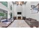 Open-concept living room with fireplace, high ceilings, large windows, and comfortable seating area at 3722 Somerset Nw Rdg, Kennesaw, GA 30144