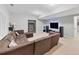 Cozy living room featuring a sectional sofa, shelving, and large screen television at 3722 Somerset Nw Rdg, Kennesaw, GA 30144
